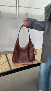 حقيبة يد نسائية متوسطة الحجم بذراع عريض باللون العنابي مع دلاية متعددة - KSA